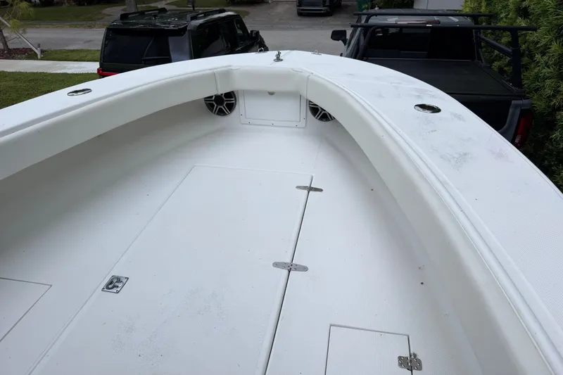 Slide: The Image of Bow view of a 2000 Ocean Runner 27 boat, featuring a spacious deck. - 24
