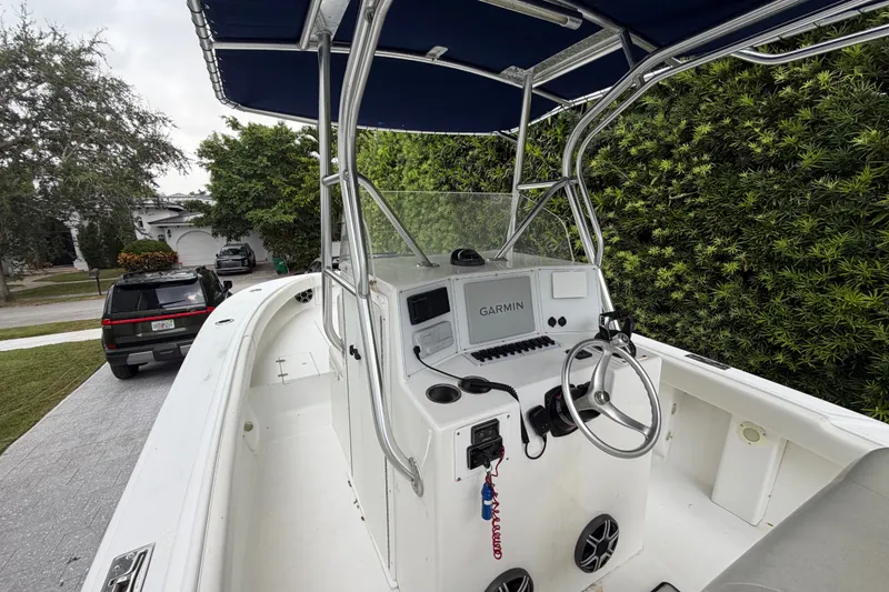 Slide: The Image of 2000 Ocean Runner 27 boat with Garmin navigation, parked in a residential driveway. - 21