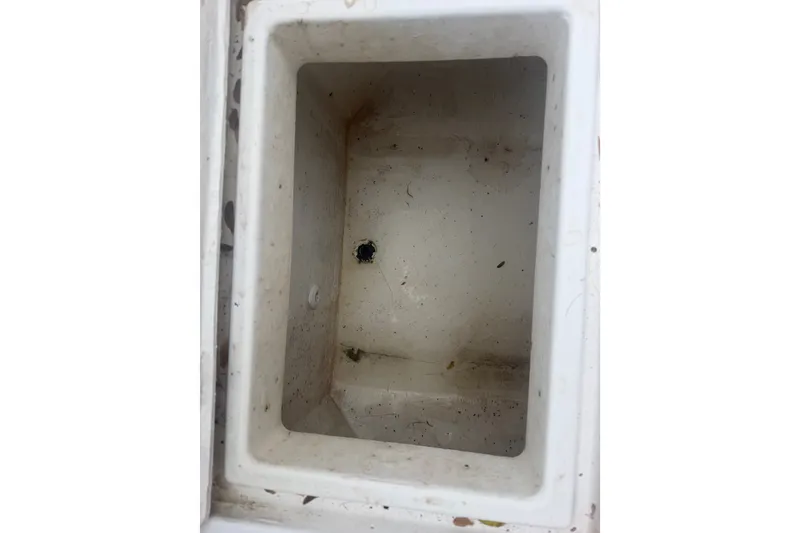 Slide: The Image of Empty storage compartment of a 2000 Ocean Runner 27 boat, showing interior details. - 26