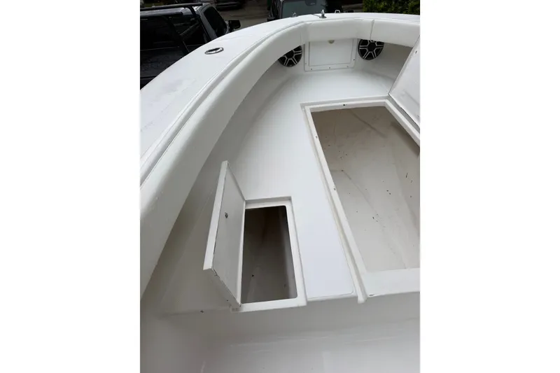 Slide: The Image of Open storage compartments on a 2000 Ocean Runner 27 boat deck. - 28