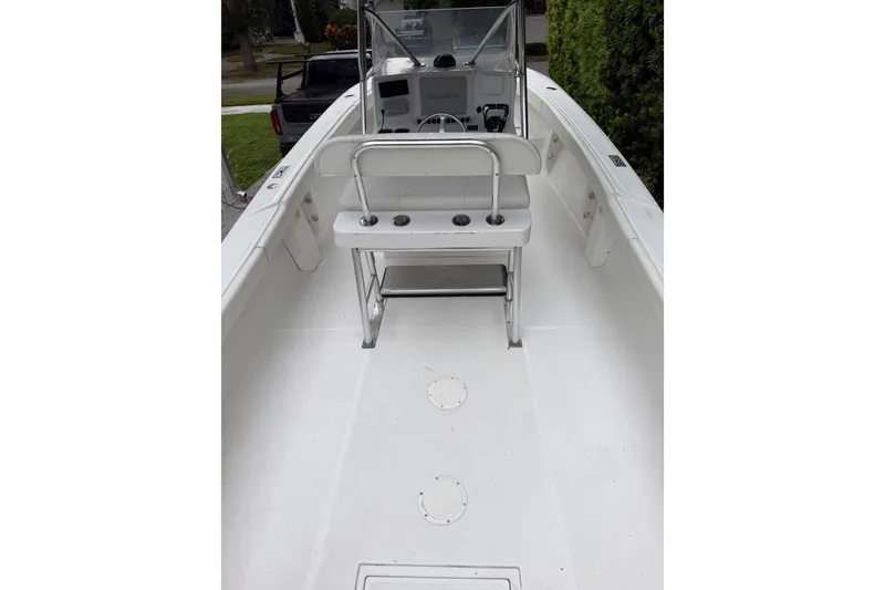 Slide: The Image of 2000 Ocean Runner 27 boat interior with console and seating, featuring a clean white deck. - 5