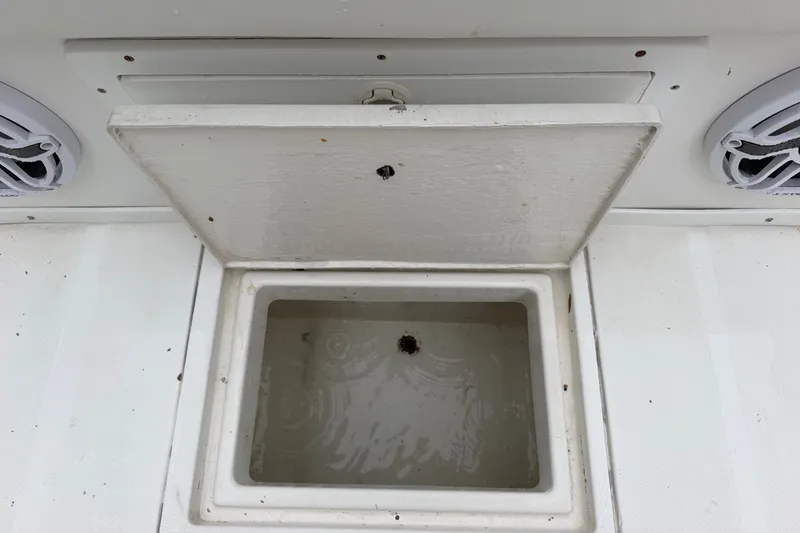 Slide: The Image of Open storage compartment on a 2000 Ocean Runner 27 boat deck. - 25