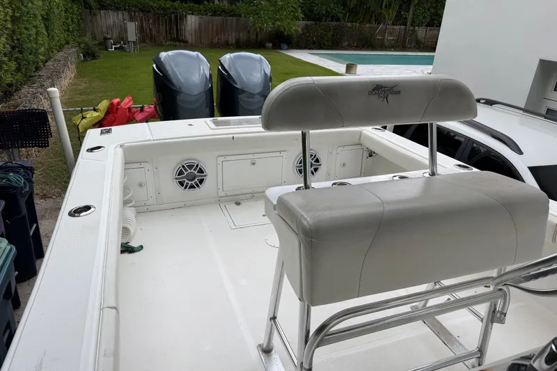 Slide: The Image of Ocean Runner 27 boat interior with seating and dual engines, year 2000 model. - 23