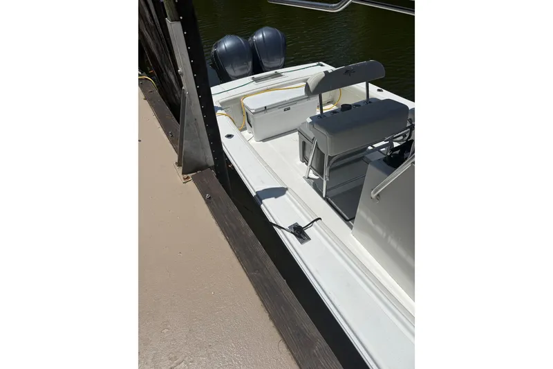 Slide: The Image of Ocean Runner 27 boat from 2000 docked, featuring dual outboard motors. - 17