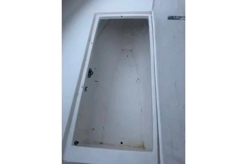 Slide: The Image of Storage compartment of a 2000 Ocean Runner 27 boat, showing interior details. - 25