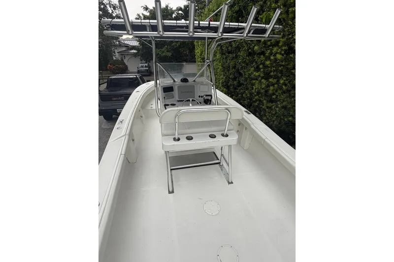 Slide: The Image of 2000 Ocean Runner 27 boat interior with steering console and rod holders. - 26