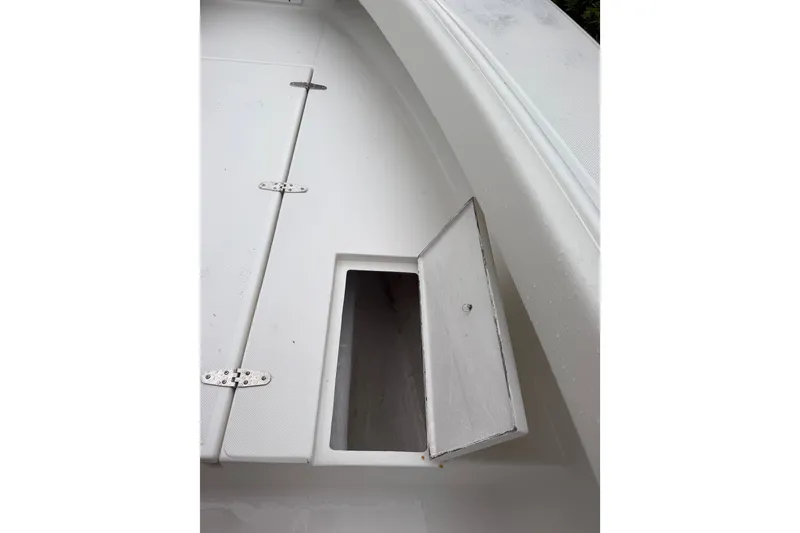 Slide: The Image of Open storage compartment on a 2000 Ocean Runner 27 boat deck. - 29