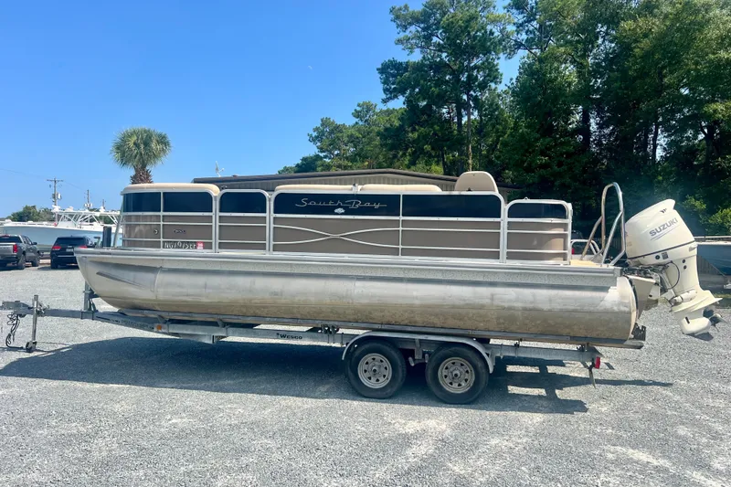 The Image of 2017 Forest River 222 pontoon boat on trailer, parked outdoors under clear blue sky. - 1