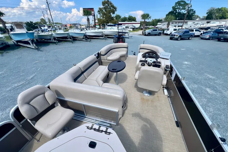 Slide: The Image of 2017 Forest River 222 pontoon boat interior with beige seating and steering console. - 14