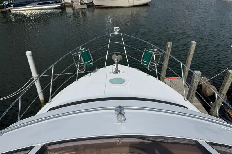 Slide: The Image of Bow view of a 2002 Carver 366 Motor Yacht docked at a marina. - 15