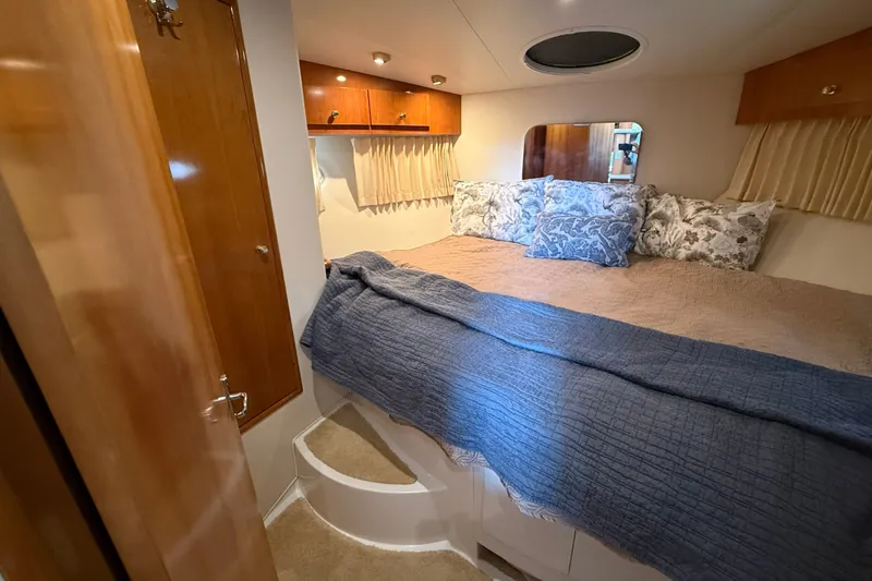 Slide: The Image of Interior of 2002 Carver 366 Motor Yacht bedroom with cozy bedding and wooden accents. - 29