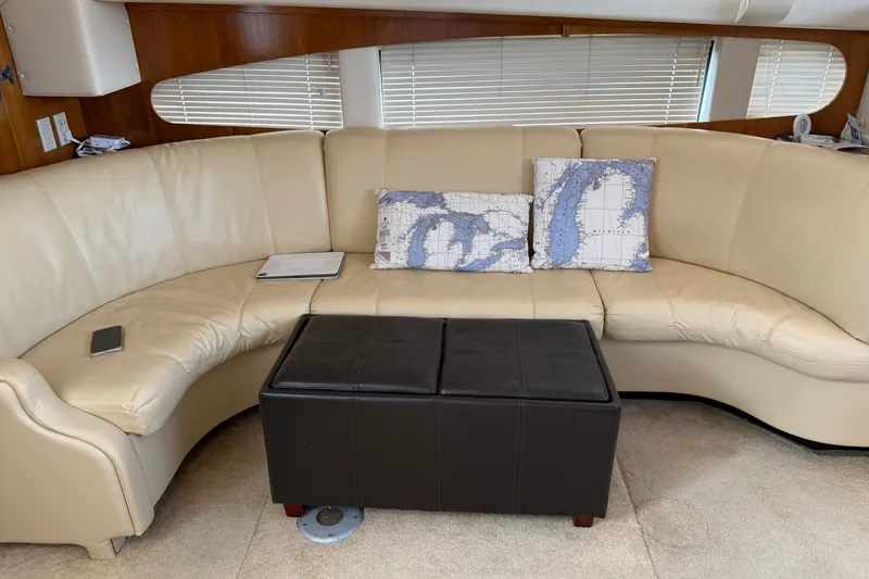 Slide: The Image of Luxurious interior of 2002 Carver 366 Motor Yacht with cream leather seating and nautical pillows. - 33