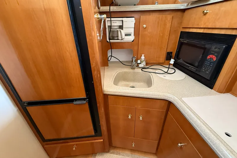 Slide: The Image of Compact kitchen area in a 2002 Carver 366 Motor Yacht with sink, microwave, and coffee maker. - 26