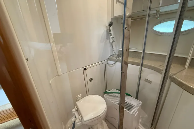 Slide: The Image of Bathroom interior of 2002 Carver 366 Motor Yacht, featuring toilet and shower area. - 28