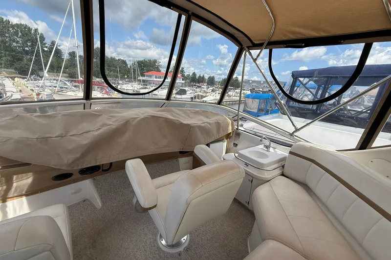 Slide: The Image of Interior view of a 2002 Carver 366 Motor Yacht with seating and helm station. - 13