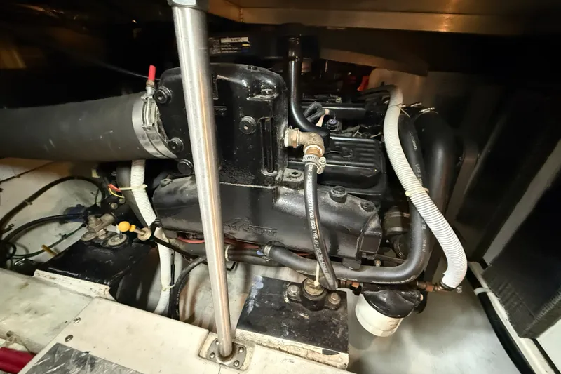 Slide: The Image of Engine compartment of a 2002 Carver 366 Motor Yacht, showcasing mechanical components and hoses. - 46