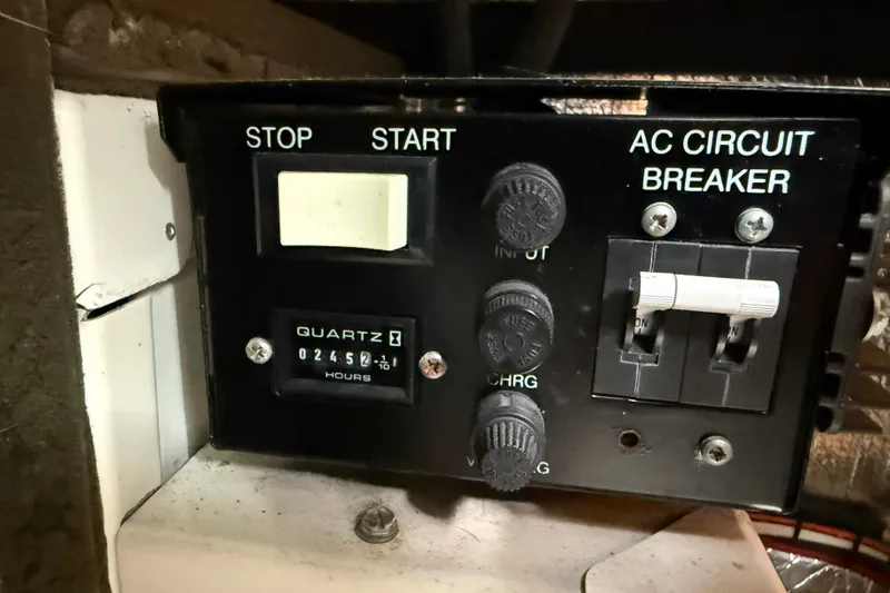 Slide: The Image of Control panel of a 2002 Carver 366 Motor Yacht with hour meter and circuit breakers. - 48