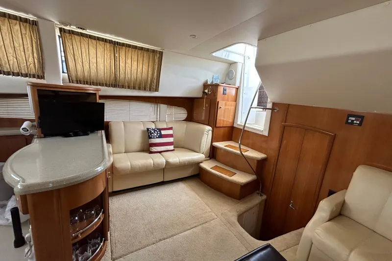 Slide: The Image of Interior of 2002 Carver 366 Motor Yacht with beige seating and American flag pillow. - 36