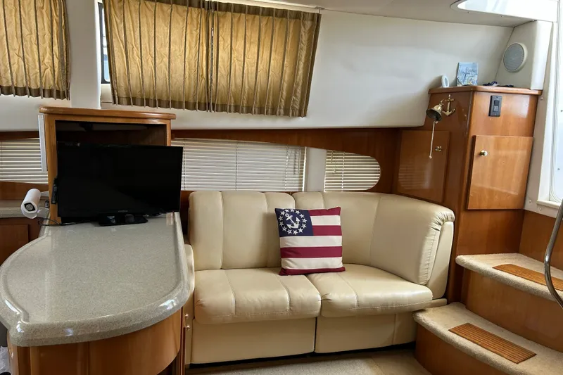 Slide: The Image of Interior of 2002 Carver 366 Motor Yacht with beige sofa and American flag pillow. - 37