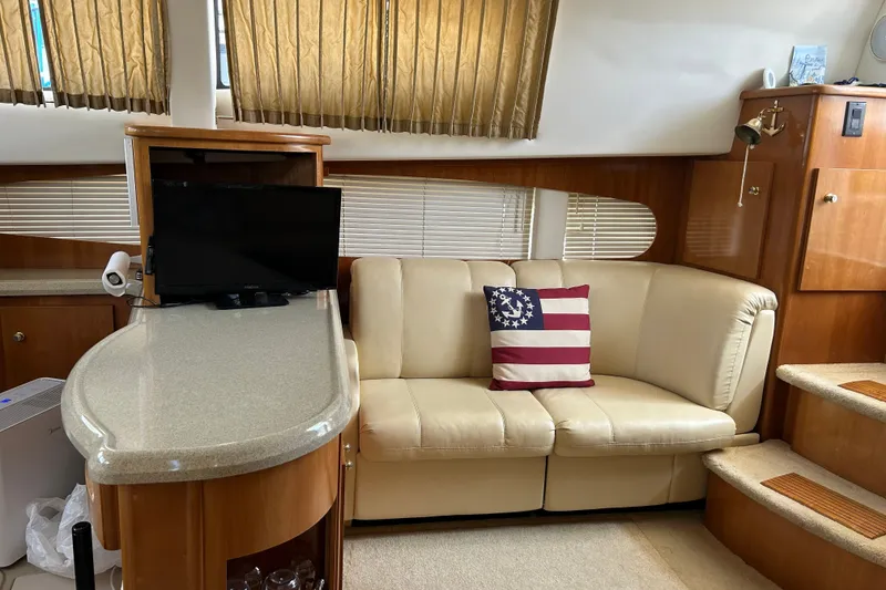 Slide: The Image of Interior of 2002 Carver 366 Motor Yacht with cream sofa and nautical-themed pillow. - 35