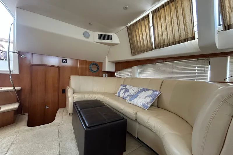 Slide: The Image of Interior of 2002 Carver 366 Motor Yacht with beige leather seating and nautical decor. - 38