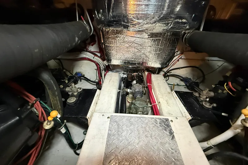 Slide: The Image of Engine room of a 2002 Carver 366 Motor Yacht, featuring mechanical components and wiring. - 43