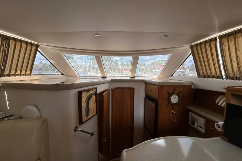 Slide: The Image of Interior of 2002 Carver 366 Motor Yacht with wood accents and large windows. - 41