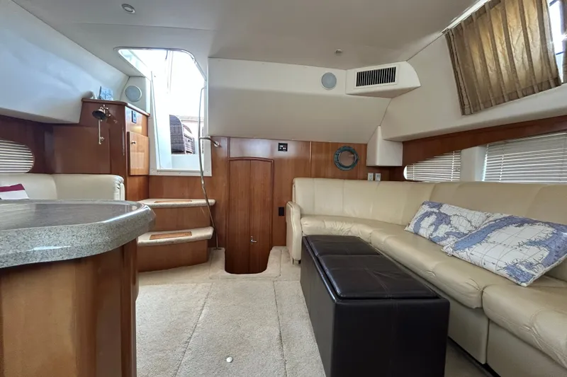Slide: The Image of Interior of 2002 Carver 366 Motor Yacht with beige seating and wooden accents. - 39