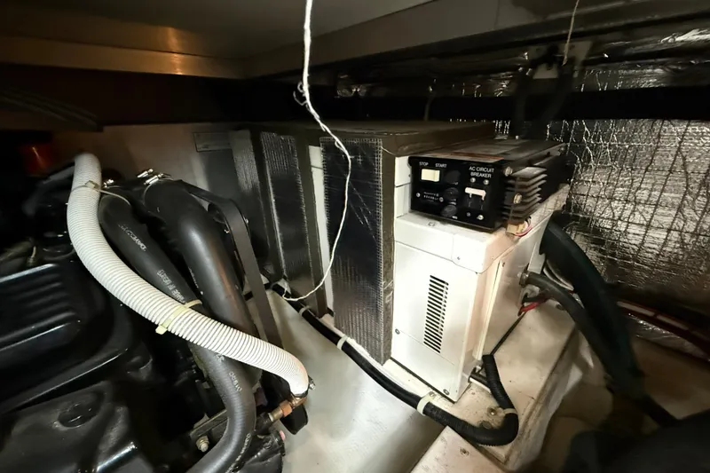 Slide: The Image of Engine room of 2002 Carver 366 Motor Yacht with visible machinery and wiring. - 47