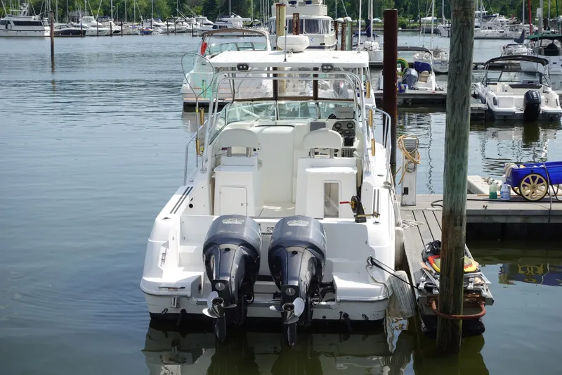 Slide: The Image of 2004 Grady-White Tournament 275 boat docked with dual outboard motors. - 3