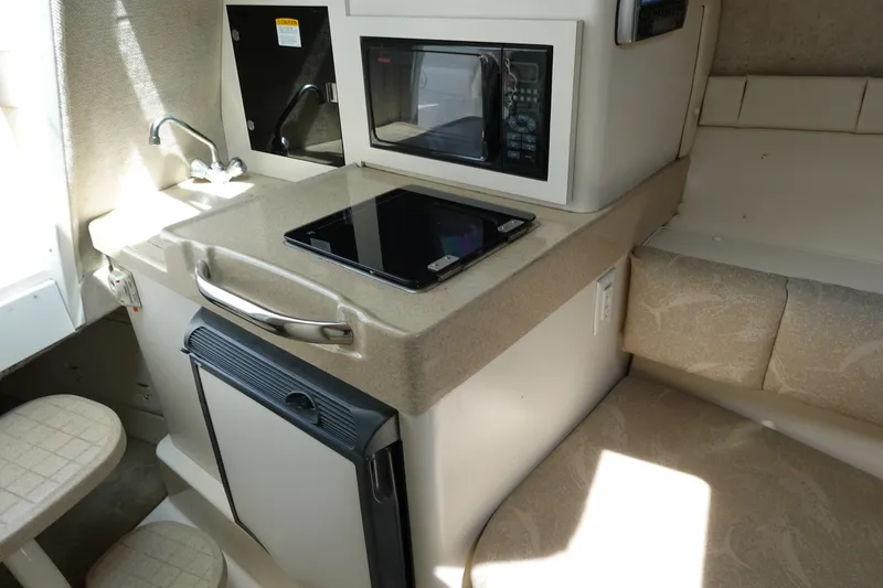 Slide: The Image of 2004 Grady-White Tournament 275 boat interior with kitchenette and seating area. - 17