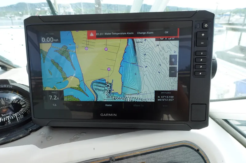 Slide: The Image of Garmin GPS display on 2004 Grady-White Tournament 275 boat, showing navigation map and water temperature alarm. - 13
