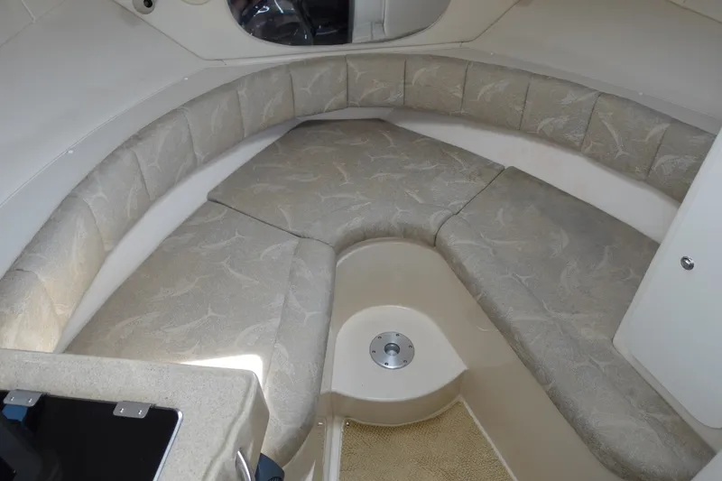 Slide: The Image of 2004 Grady-White Tournament 275 boat interior with cushioned seating and beige upholstery. - 14