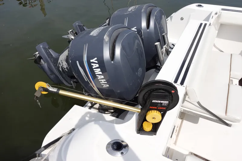 Slide: The Image of 2004 Grady-White Tournament 275 boat with dual Yamaha outboard motors and fishing reel setup. - 6
