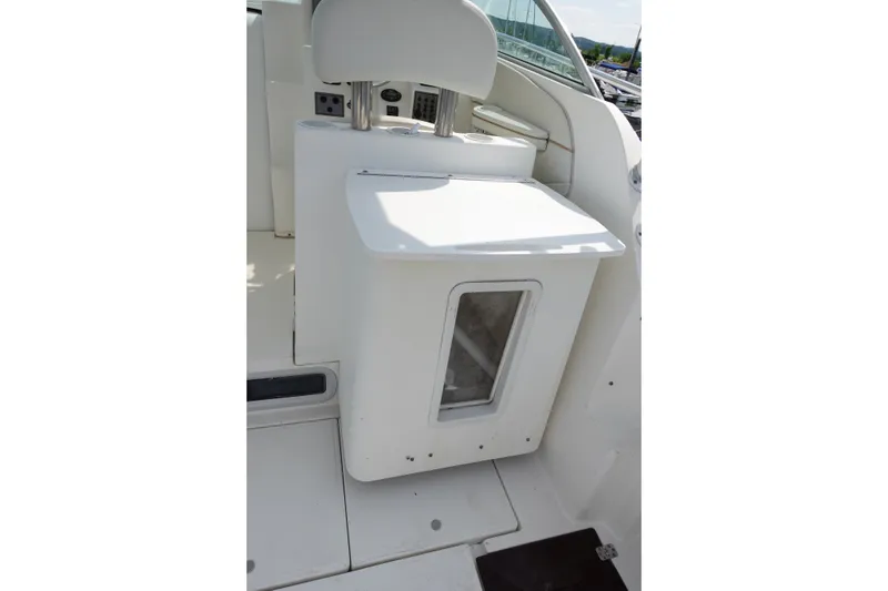 Slide: The Image of 2004 Grady-White Tournament 275 boat interior with seating and storage compartment. - 10