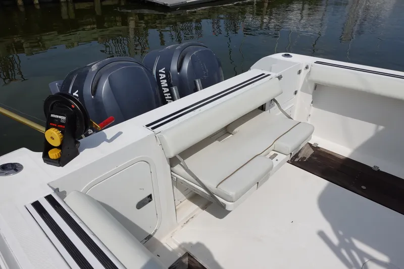 Slide: The Image of 2004 Grady-White Tournament 275 boat with Yamaha engines and seating, docked by the water. - 7