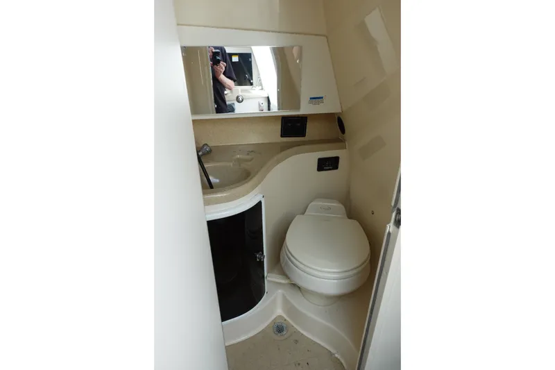 Slide: The Image of 2004 Grady-White Tournament 275 boat bathroom with sink, toilet, and mirror. - 22