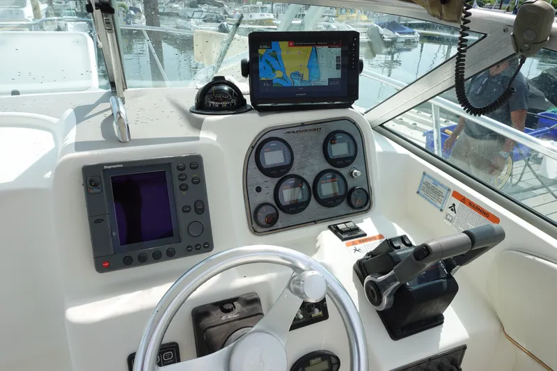 Slide: The Image of 2004 Grady-White Tournament 275 boat dashboard with navigation and control instruments. - 11