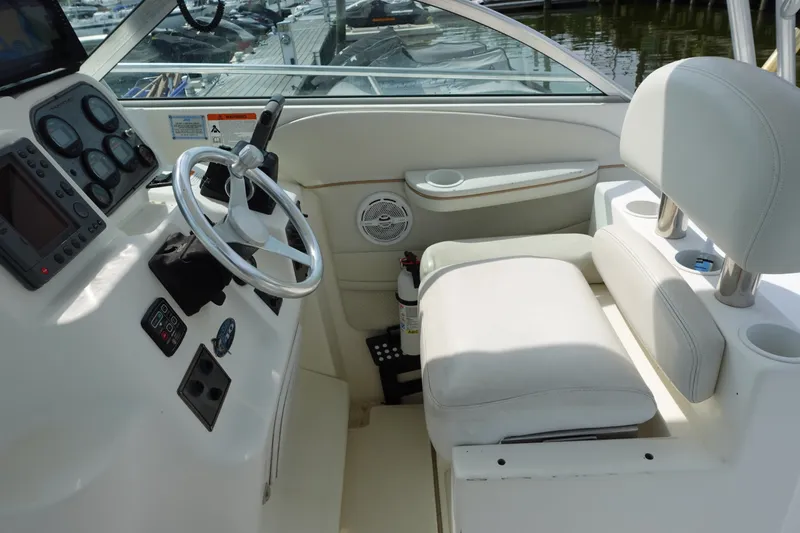 Slide: The Image of 2004 Grady-White Tournament 275 boat cockpit with steering wheel and control panel. - 12