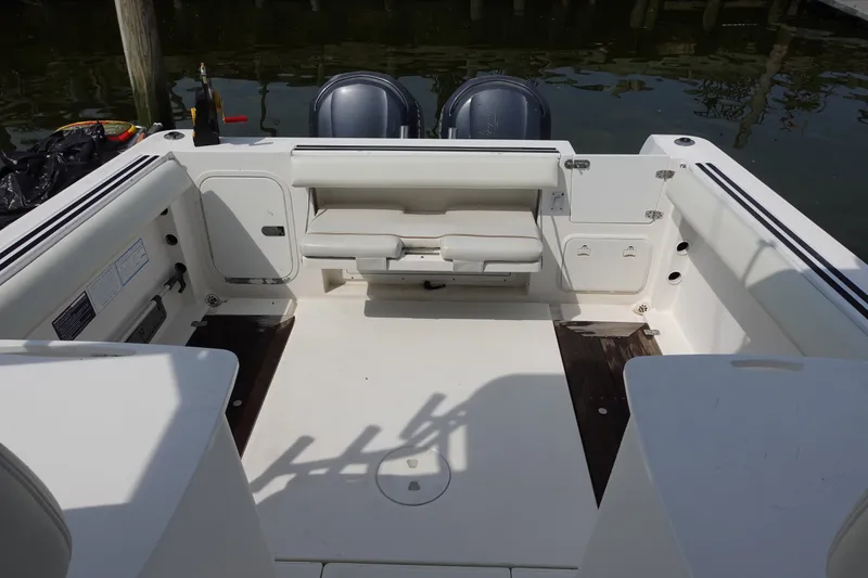 Slide: The Image of 2004 Grady-White Tournament 275 boat interior with seating and storage compartments. - 8
