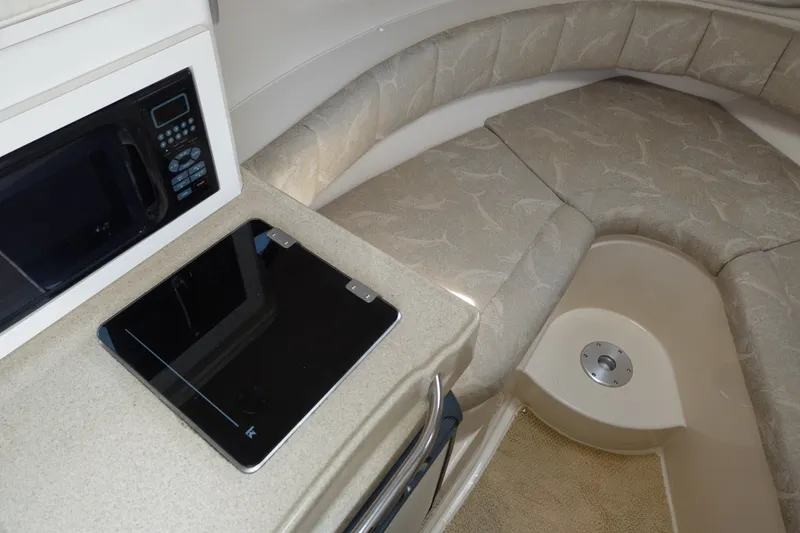 Slide: The Image of Interior of 2004 Grady-White Tournament 275 boat with seating and kitchenette area. - 18