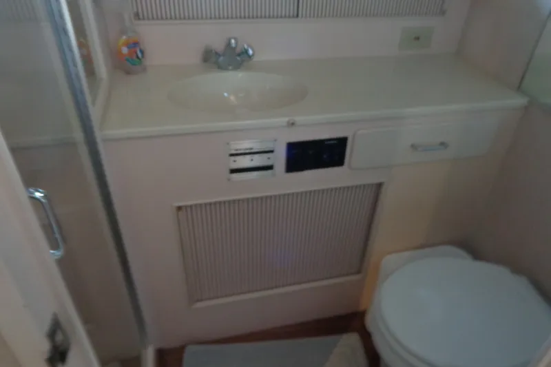Slide: The Image of Bathroom interior of 1989 Tollycraft 34 Sport Sedan with sink and toilet. - 27