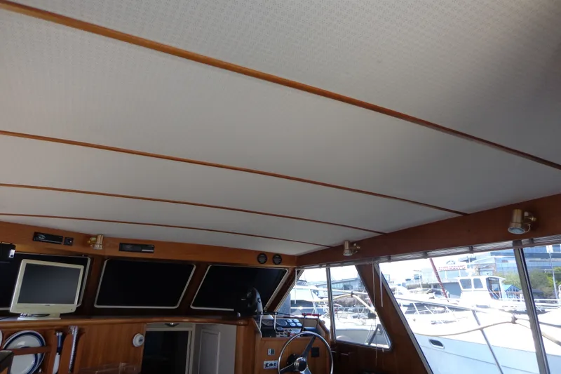 Slide: The Image of Interior of 1989 Tollycraft 34 Sport Sedan with helm, windows, and ceiling details. - 58