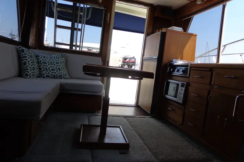 Slide: The Image of Interior of 1989 Tollycraft 34 Sport Sedan with cozy seating and kitchenette. - 28