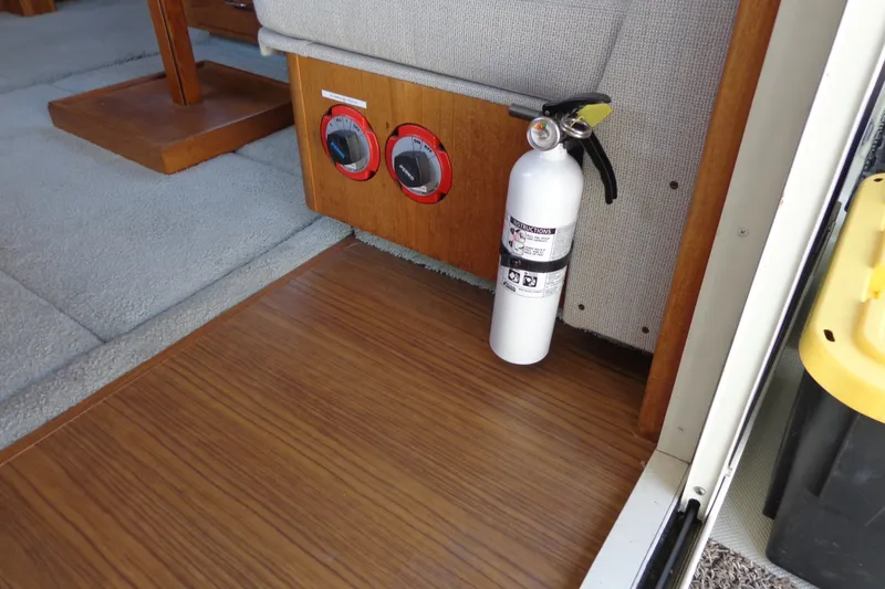 Slide: The Image of 1989 Tollycraft 34 Sport Sedan interior with fire extinguisher and control panel. - 46