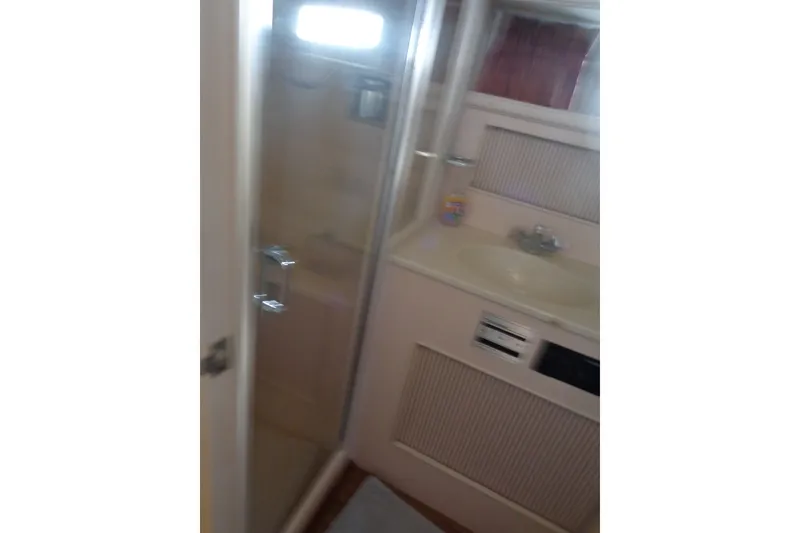 Slide: The Image of Bathroom interior of 1989 Tollycraft 34 Sport Sedan with shower and sink. - 26
