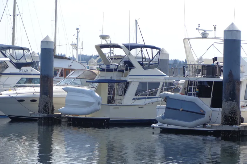 Slide: The Image of 1989 Tollycraft 34 Sport Sedan docked at marina with other boats. - 62