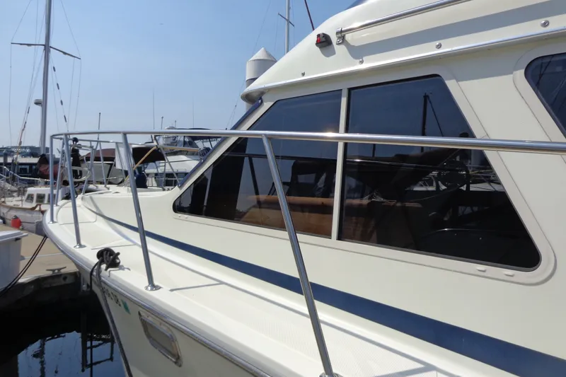 Slide: The Image of 1989 Tollycraft 34 Sport Sedan yacht docked at marina, side view. - 59