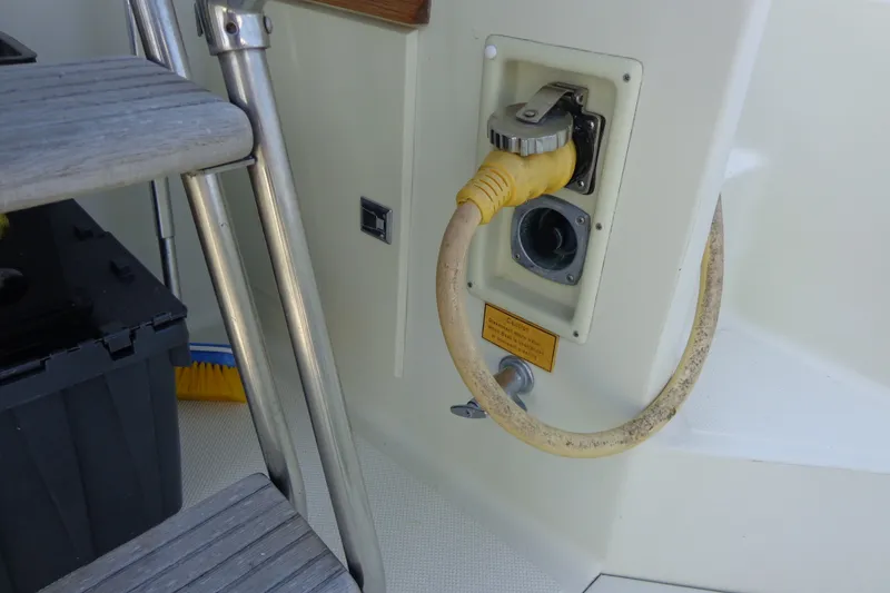 Slide: The Image of 1989 Tollycraft 34 Sport Sedan power connection with yellow cable and metal ladder. - 42