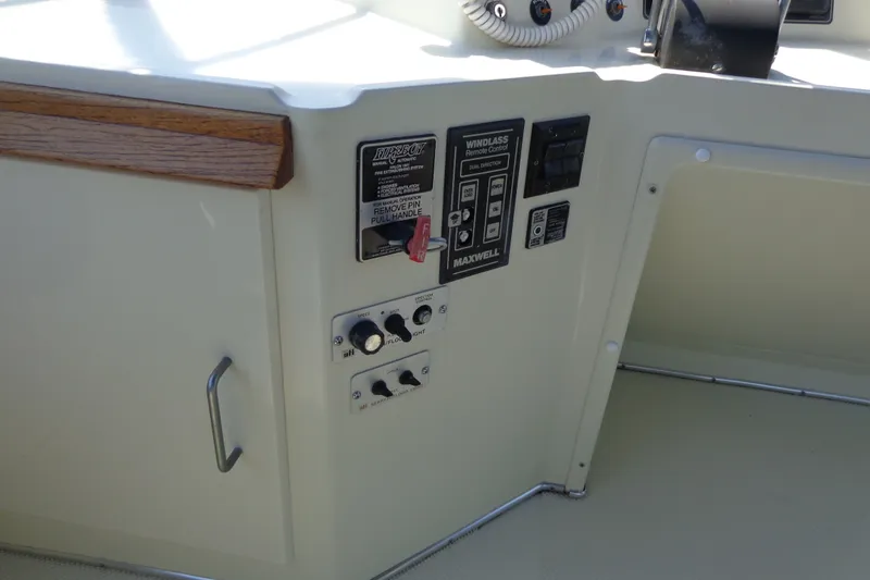 Slide: The Image of Control panel on a 1989 Tollycraft 34 Sport Sedan boat, featuring various switches and dials. - 53